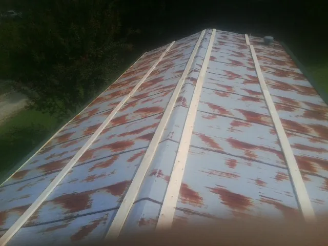 Rusted metal roof panels with new wood purlins before replacement — Storm Damage Roof Repair in Florahome by Roofing Brothers